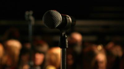 a microphone in the foreground with other microphones in the background