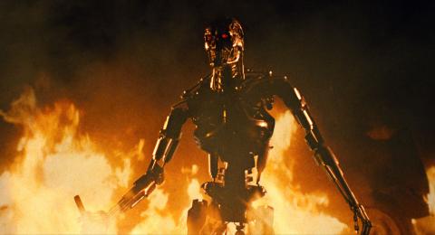 still from Terminator film with the title character engulfed in flames