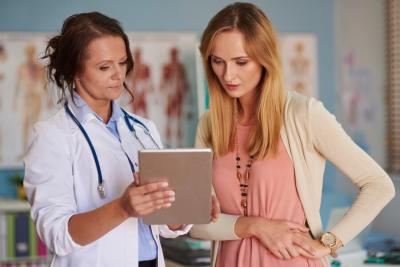 A doctor shares health information with their patient in a doctor's office.