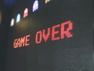 Image of a video game screen that reads "Game Over" in red letters.