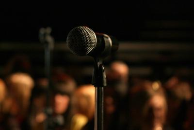 a microphone in the foreground with other microphones in the background